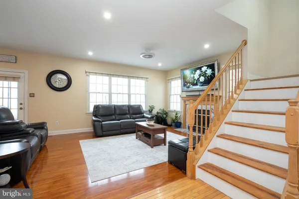 a view of a livingroom with wooden floor and a flat screen tv
