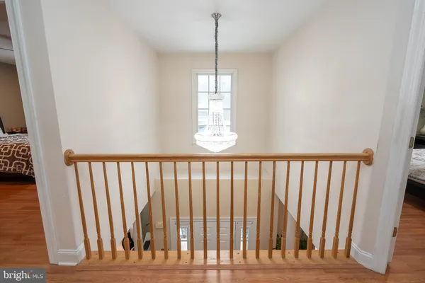 a bedroom with a bed and a flat tv screen on dresser