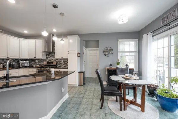a large kitchen with a table and chairs