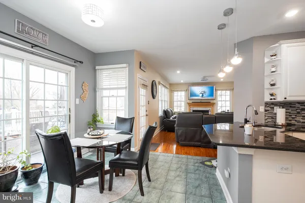 a dining room with furniture a rug and a potted plant