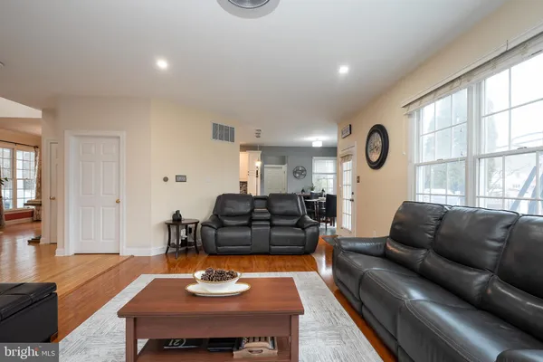 a living room with furniture fireplace and a window