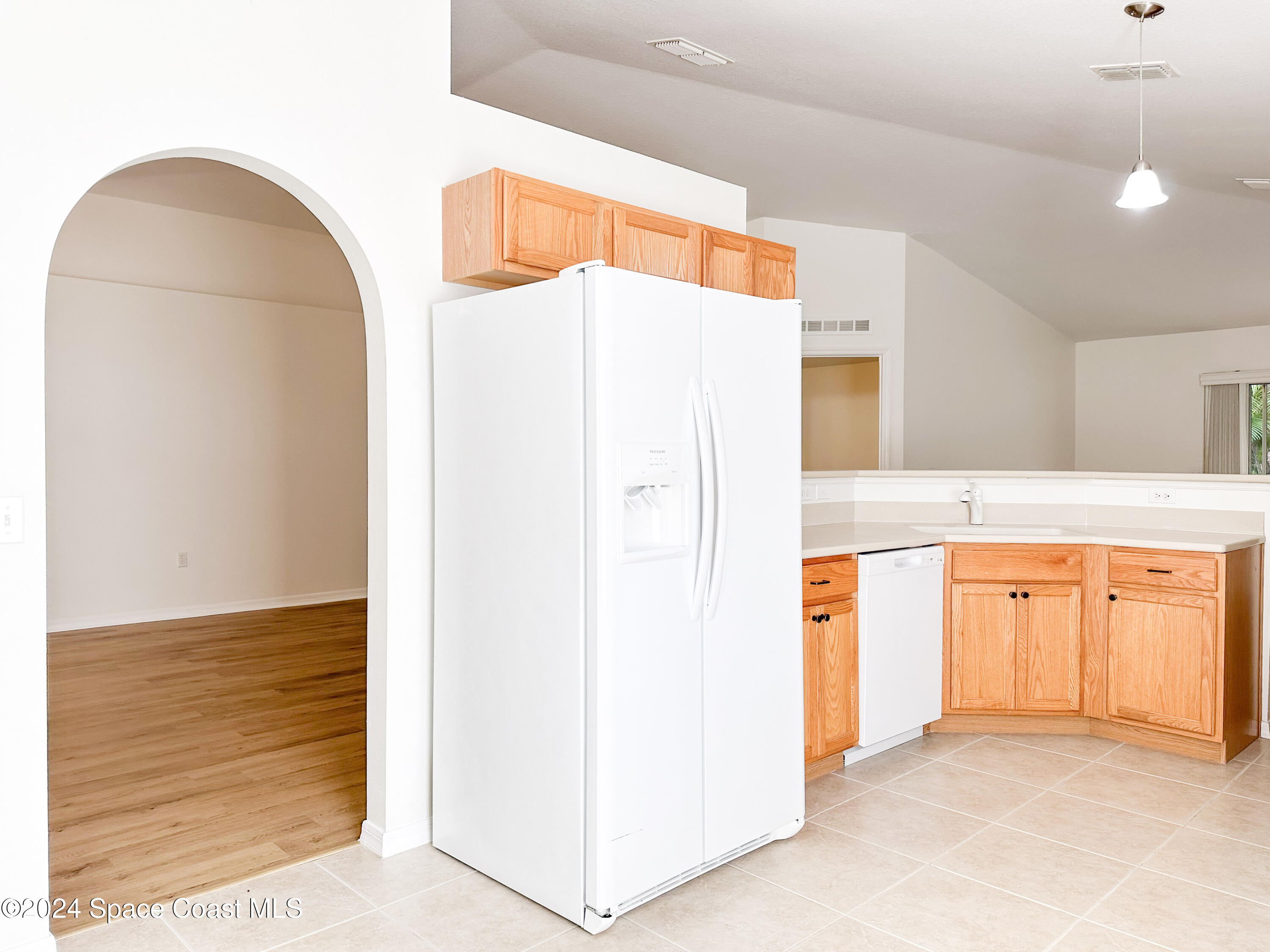 152 Morgan Circle Sebastian, FL 32958 - Photo 11 of 64 a view of a kitchen with refrigerator and wooden floor