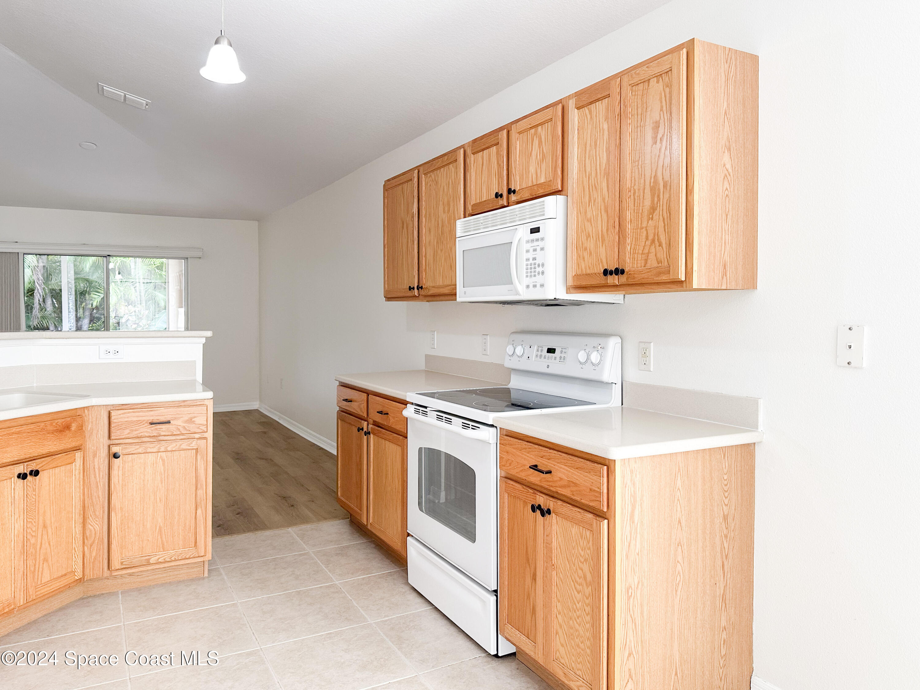 152 Morgan Circle Sebastian, FL 32958 - Photo 14 of 64 a kitchen with stainless steel appliances sink a stove and white cabinets