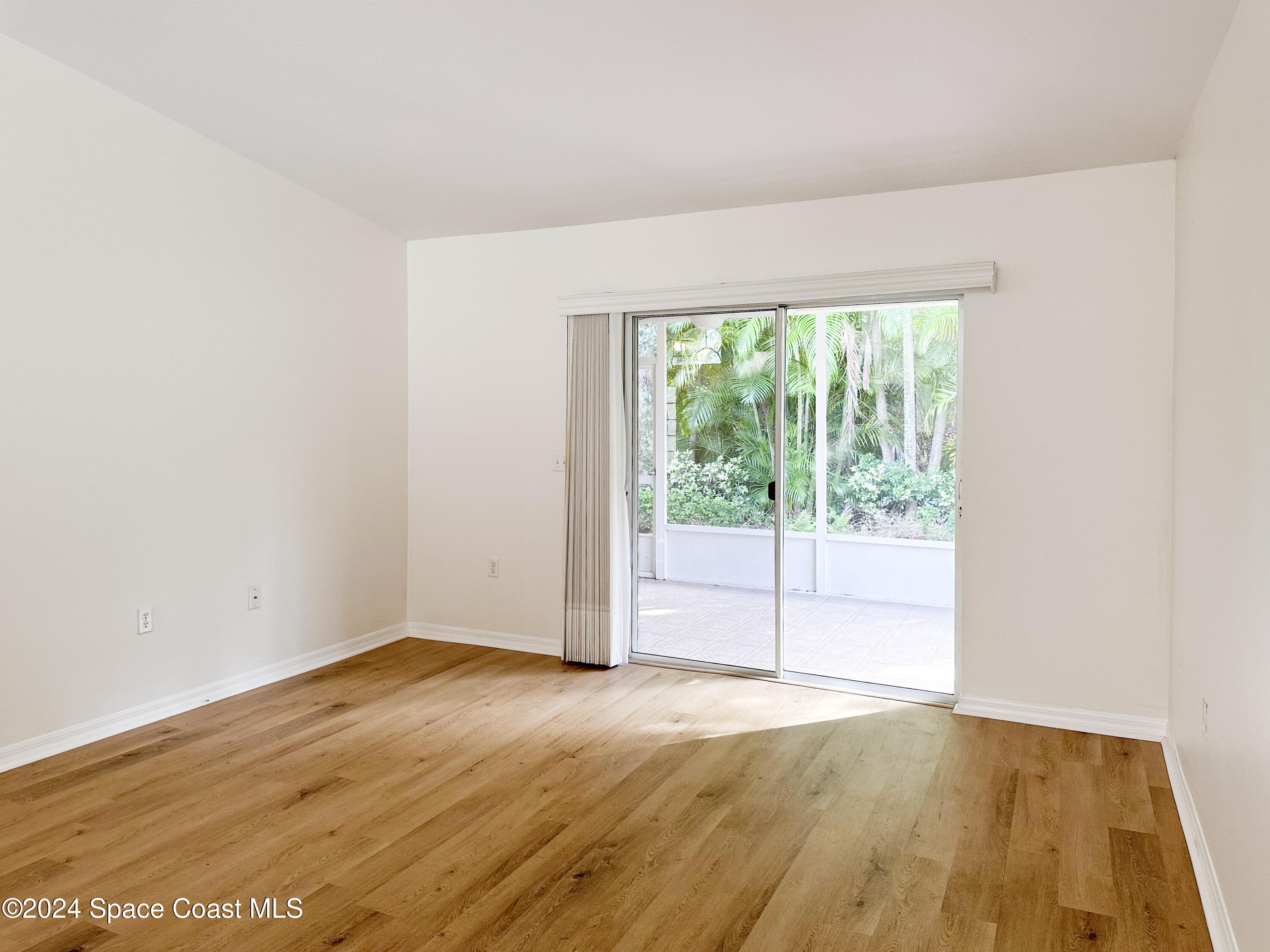 152 Morgan Circle Sebastian, FL 32958 - Photo 20 of 64 a view of empty room with wooden floor and fan