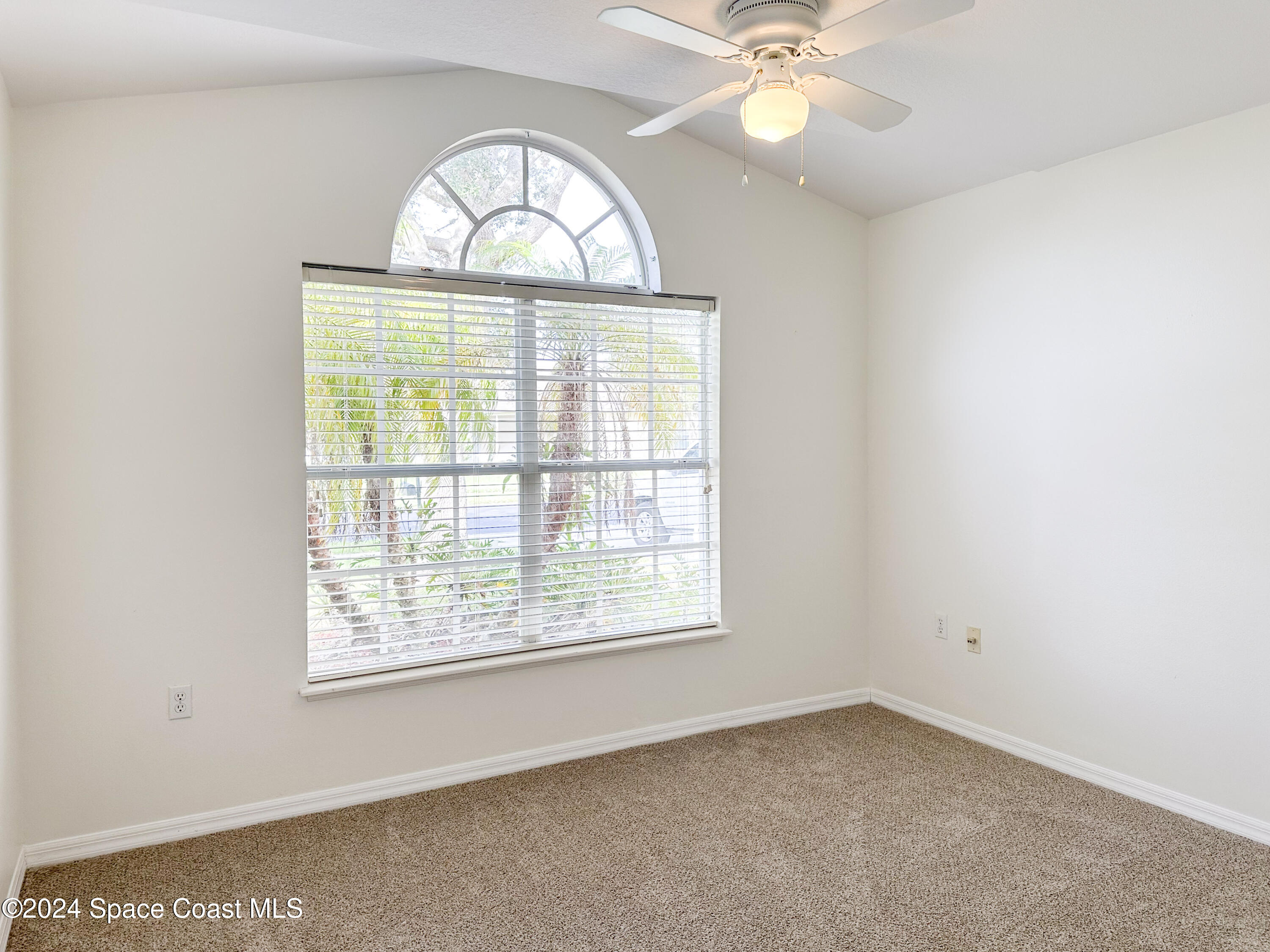 152 Morgan Circle Sebastian, FL 32958 - Photo 21 of 64 an empty room with a window and a chandelier
