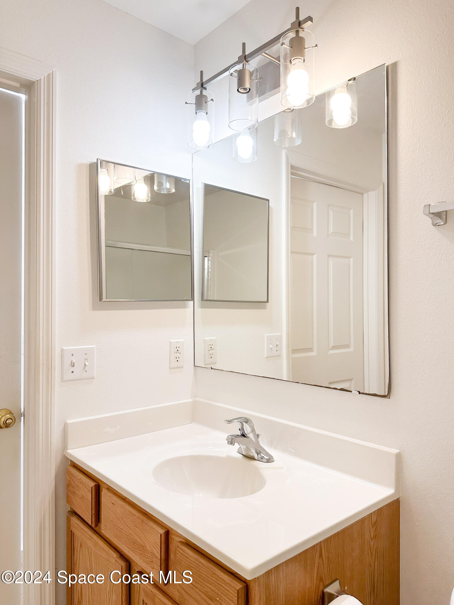 152 Morgan Circle Sebastian, FL 32958 - Photo 28 of 64 a bathroom with a sink and a mirror