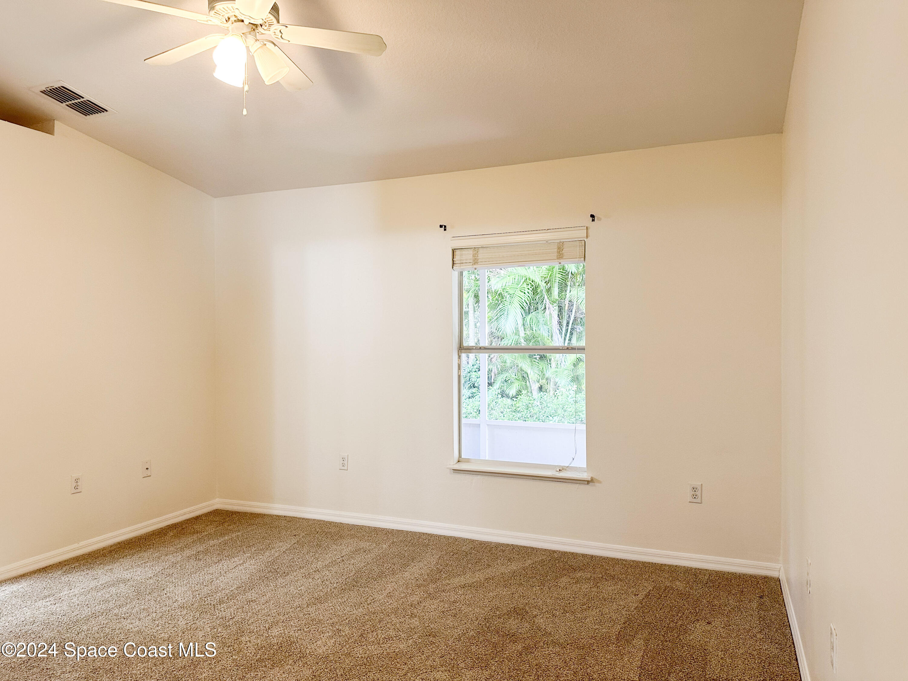 152 Morgan Circle Sebastian, FL 32958 - Photo 29 of 64 an empty room with a window and a fan