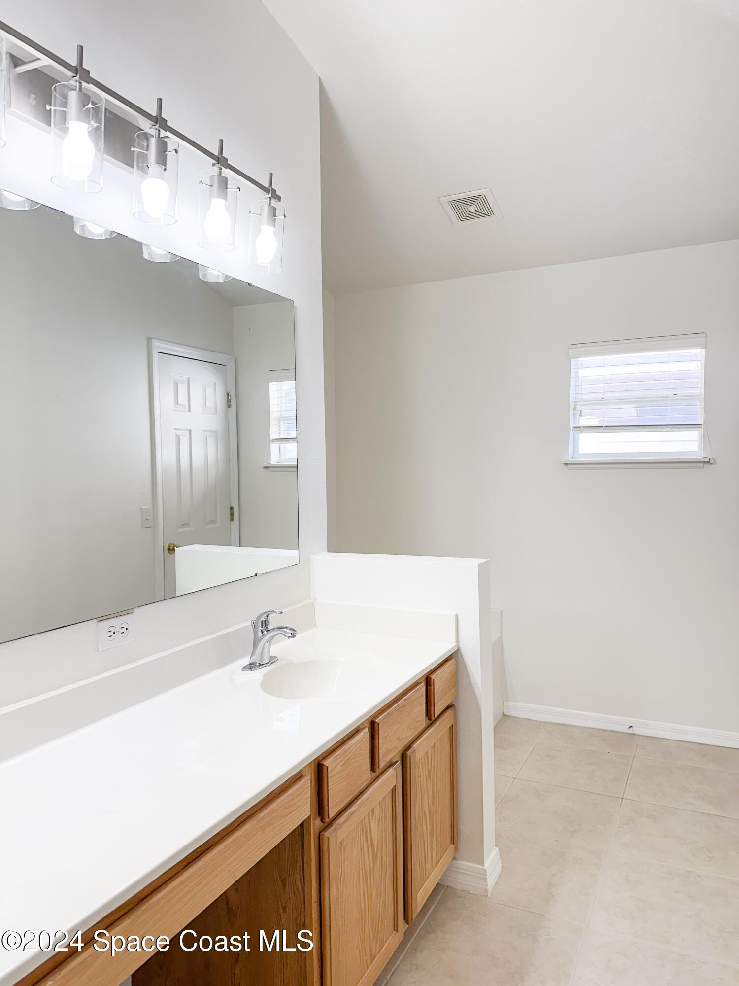 152 Morgan Circle Sebastian, FL 32958 - Photo 31 of 64 a bathroom with a sink a vanity and a mirror
