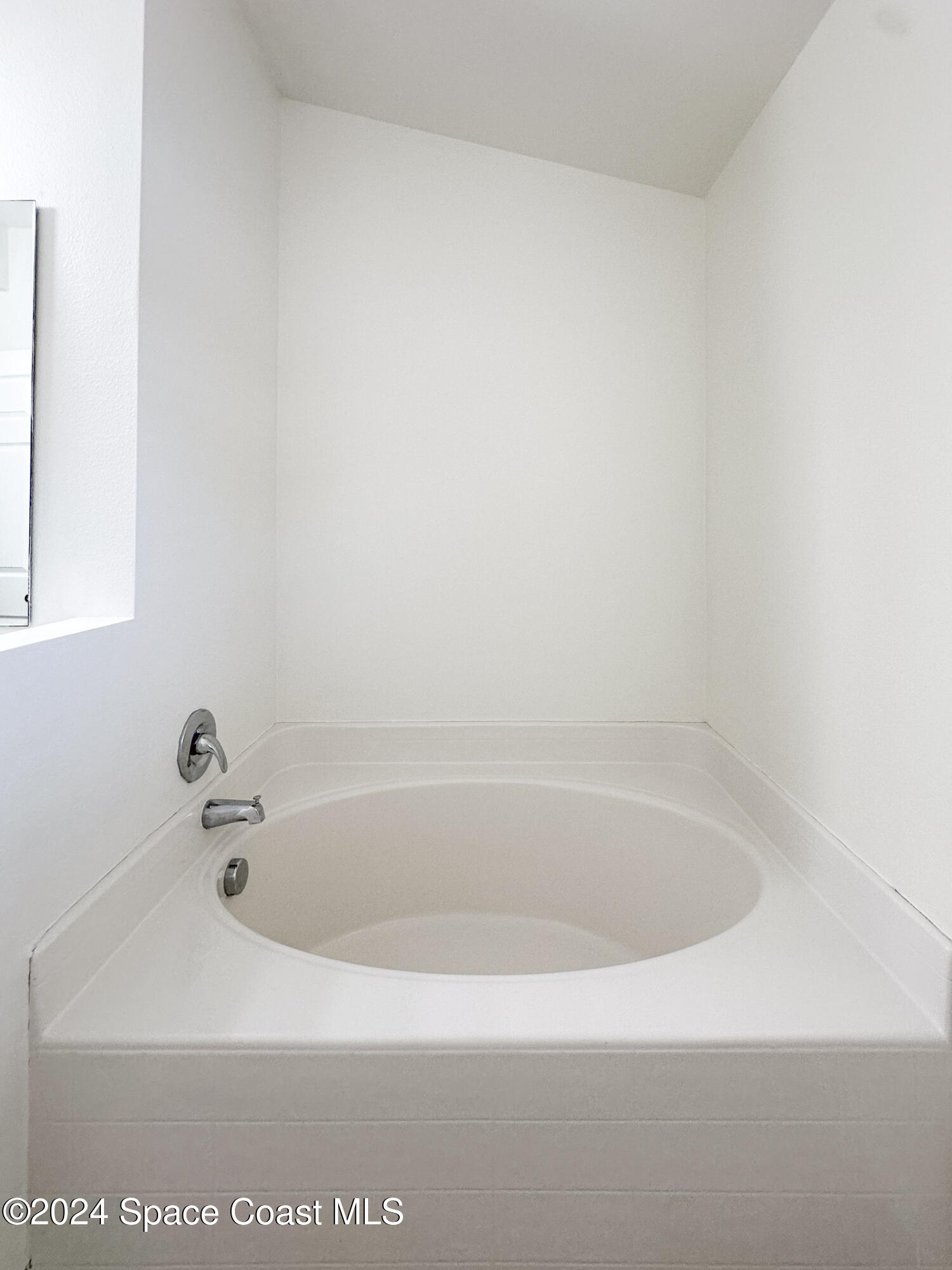 152 Morgan Circle Sebastian, FL 32958 - Photo 34 of 64 a white bath tub sitting in a bathroom