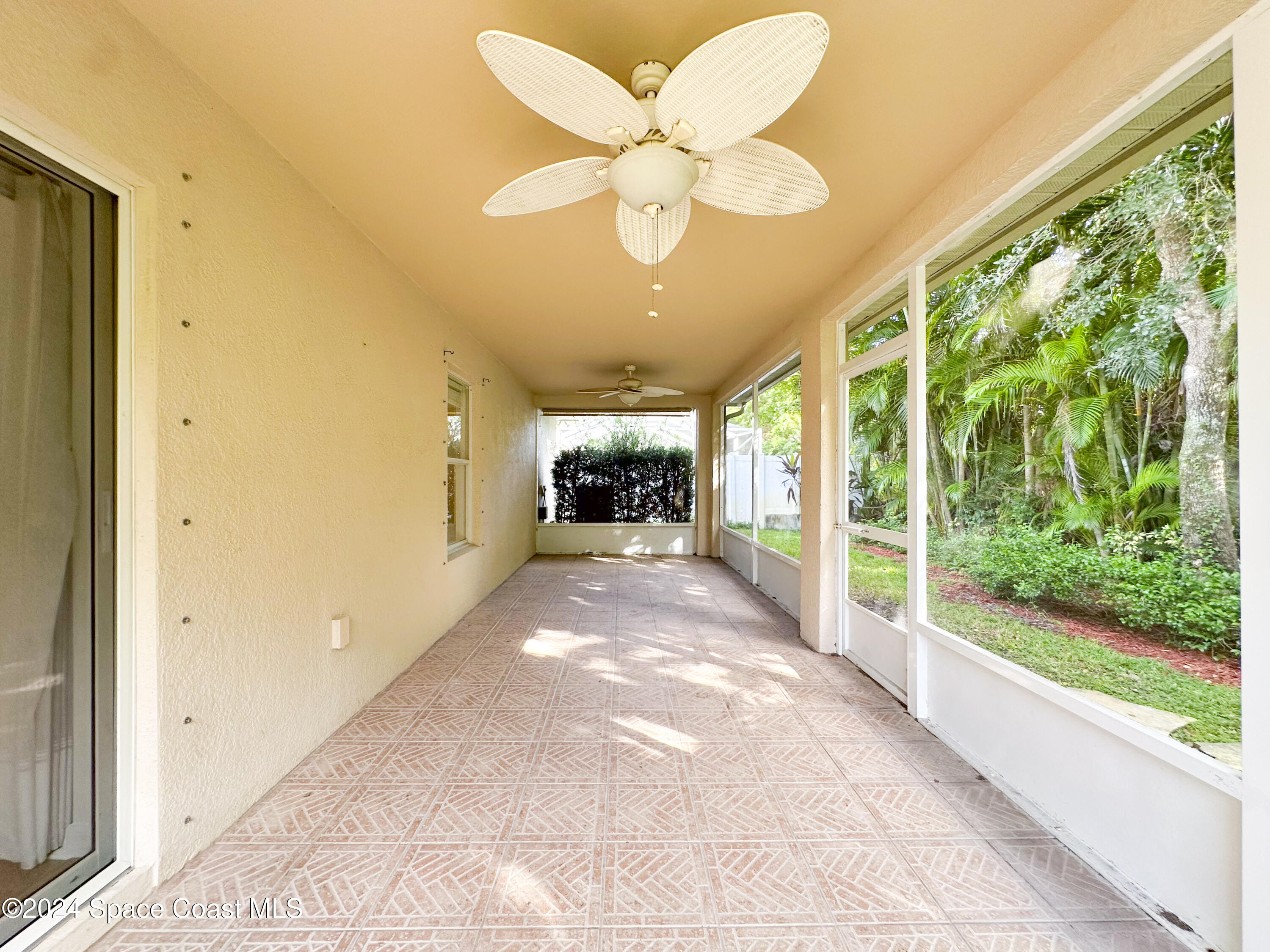 152 Morgan Circle Sebastian, FL 32958 - Photo 39 of 64 a view of a porch with a floor to ceiling window and a swimming pool
