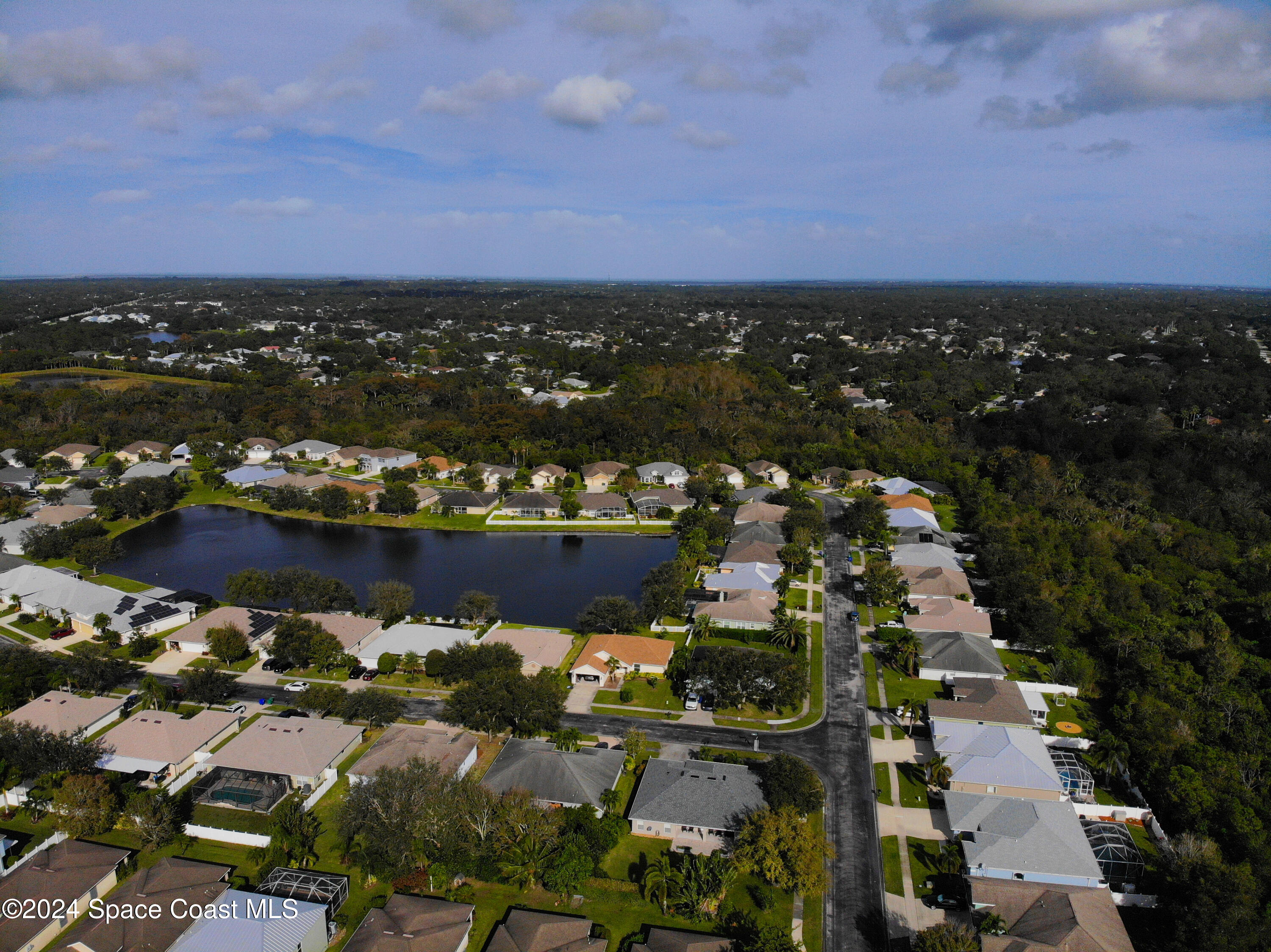 152 Morgan Circle Sebastian, FL 32958 - Photo 58 of 64 an aerial view of a city with lots of residential buildings ocean and mountain view in back