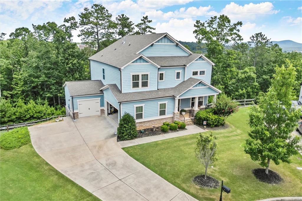 a aerial view of a house with a yard and potted plants