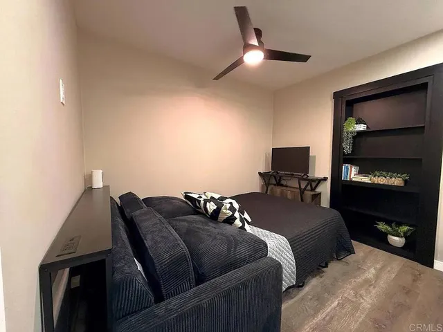 a bed room with a bed and a television