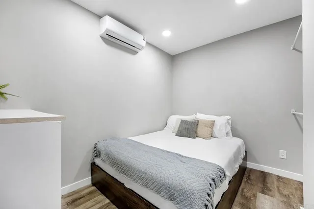 a bedroom with a bed and a night stand