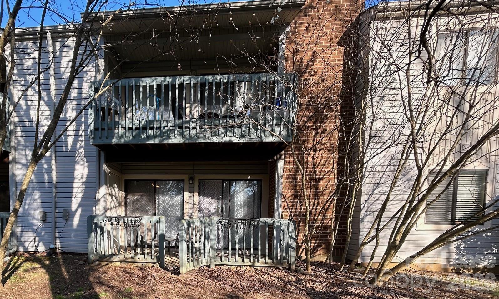 11028 Harrowfield Road Charlotte, NC 28226 - Photo 14 of 15 a view of a small house with large trees