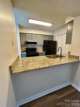 a kitchen with granite countertop counter top space cabinets and stainless steel appliances