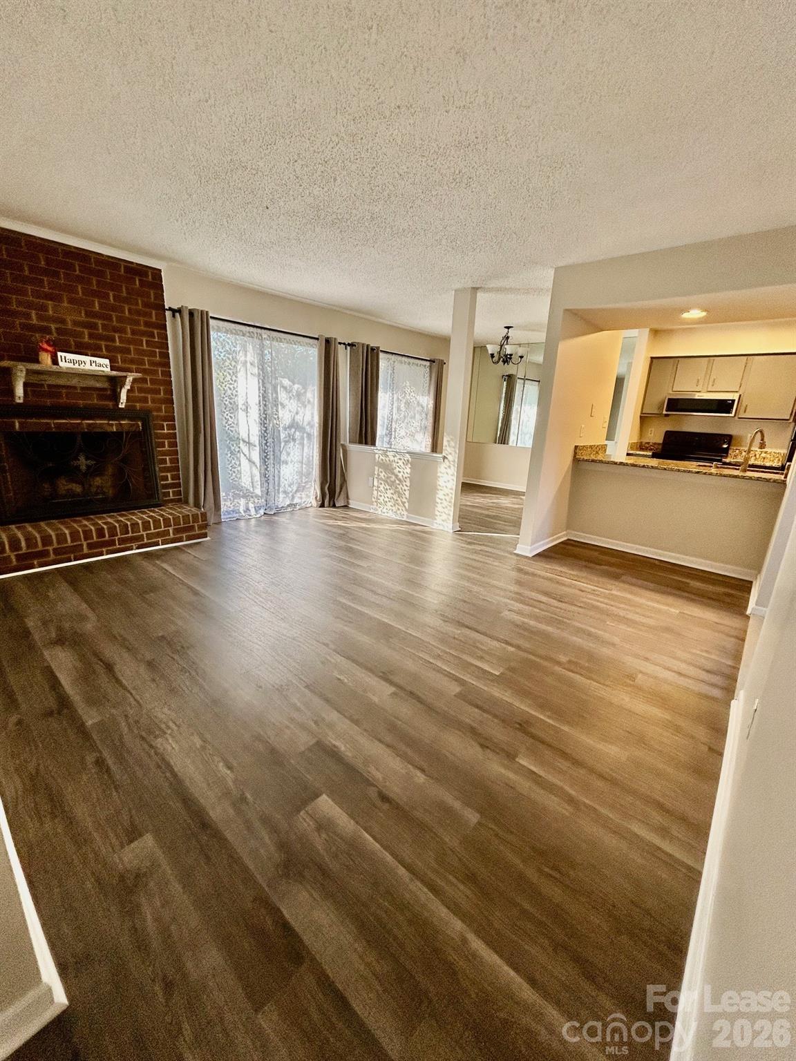 11028 Harrowfield Road Charlotte, NC 28226 - Photo 8 of 15 a view of an empty room with wooden floor and a window