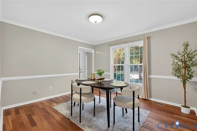a view of a dining room with furniture and wooden floor