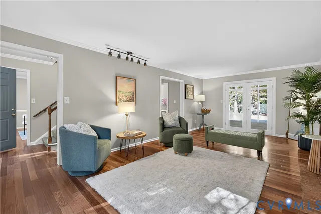 a living room with furniture and wooden floor