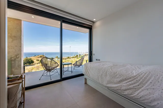 a bedroom with a bed and large window