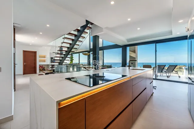 a kitchen with stainless steel appliances a sink and a large window