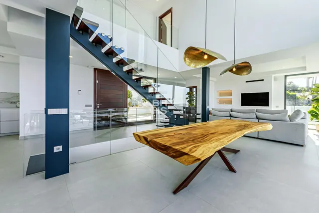 a living room with pool table and windows