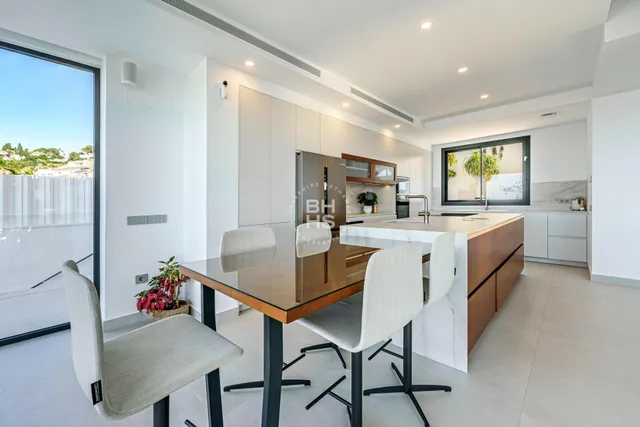 a kitchen with a cabinets and chairs