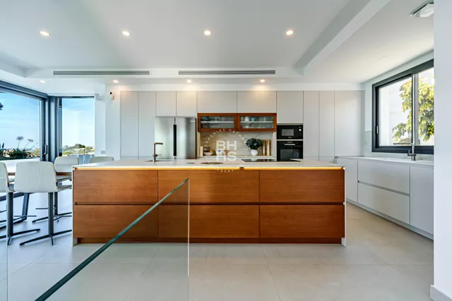 a room with stainless steel appliances lots of counter top space