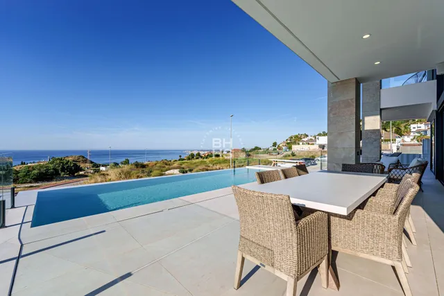 a view of a dining room with furniture and a kitchen