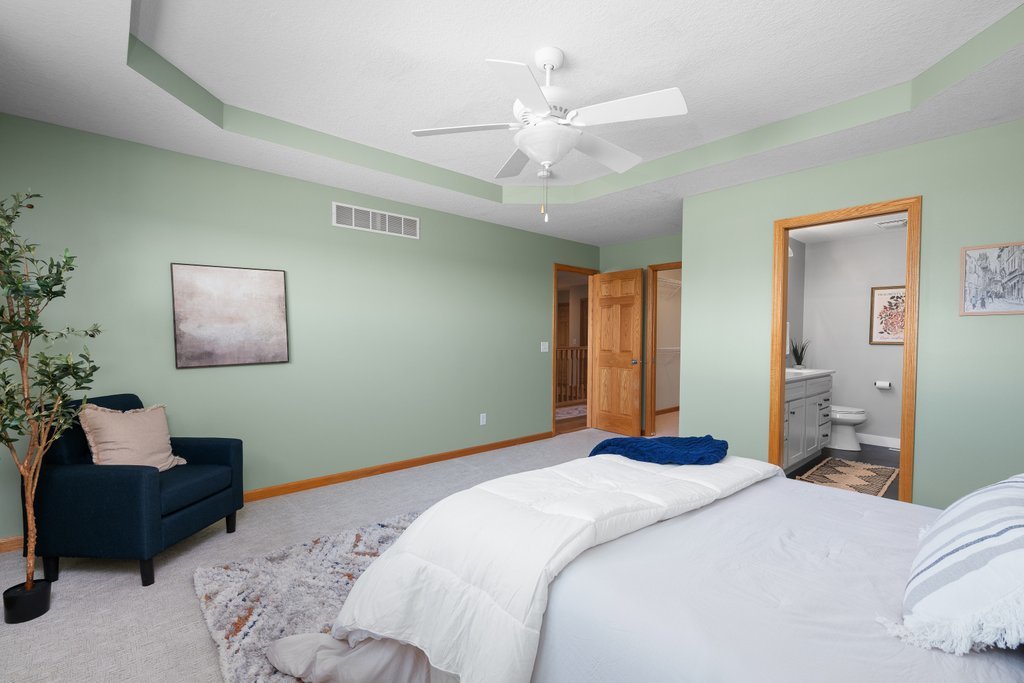 1126 West Le Claire Road Eldridge, IA 52748 - Photo 13 of 44 a bedroom with a bed and a couch