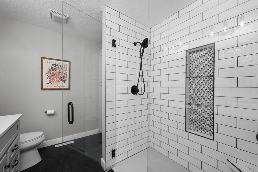 1126 West Le Claire Road Eldridge, IA 52748 - Photo 15 of 44 a bathroom with a shower and a toilet