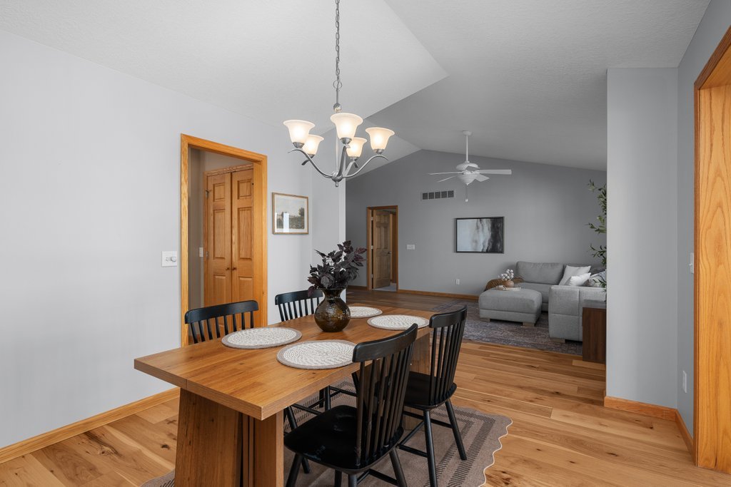 1126 West Le Claire Road Eldridge, IA 52748 - Photo 19 of 44 a view of a dining room with furniture and wooden floor