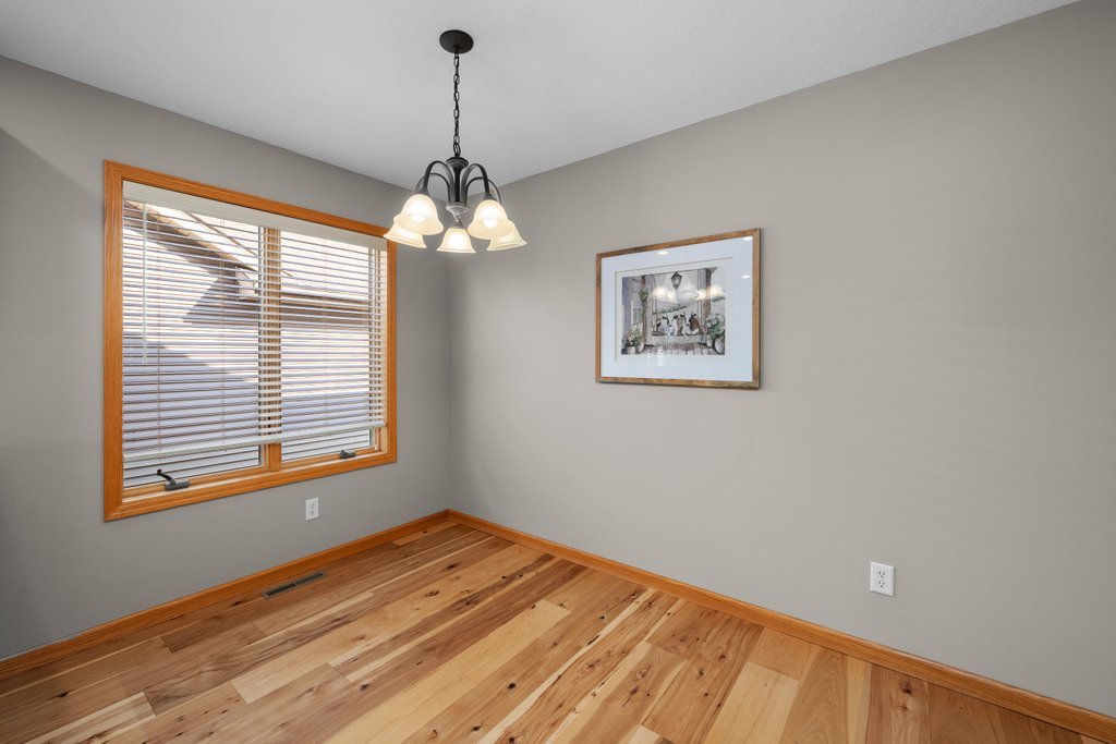 1126 West Le Claire Road Eldridge, IA 52748 - Photo 23 of 44 a view of an empty room with window and wooden floor