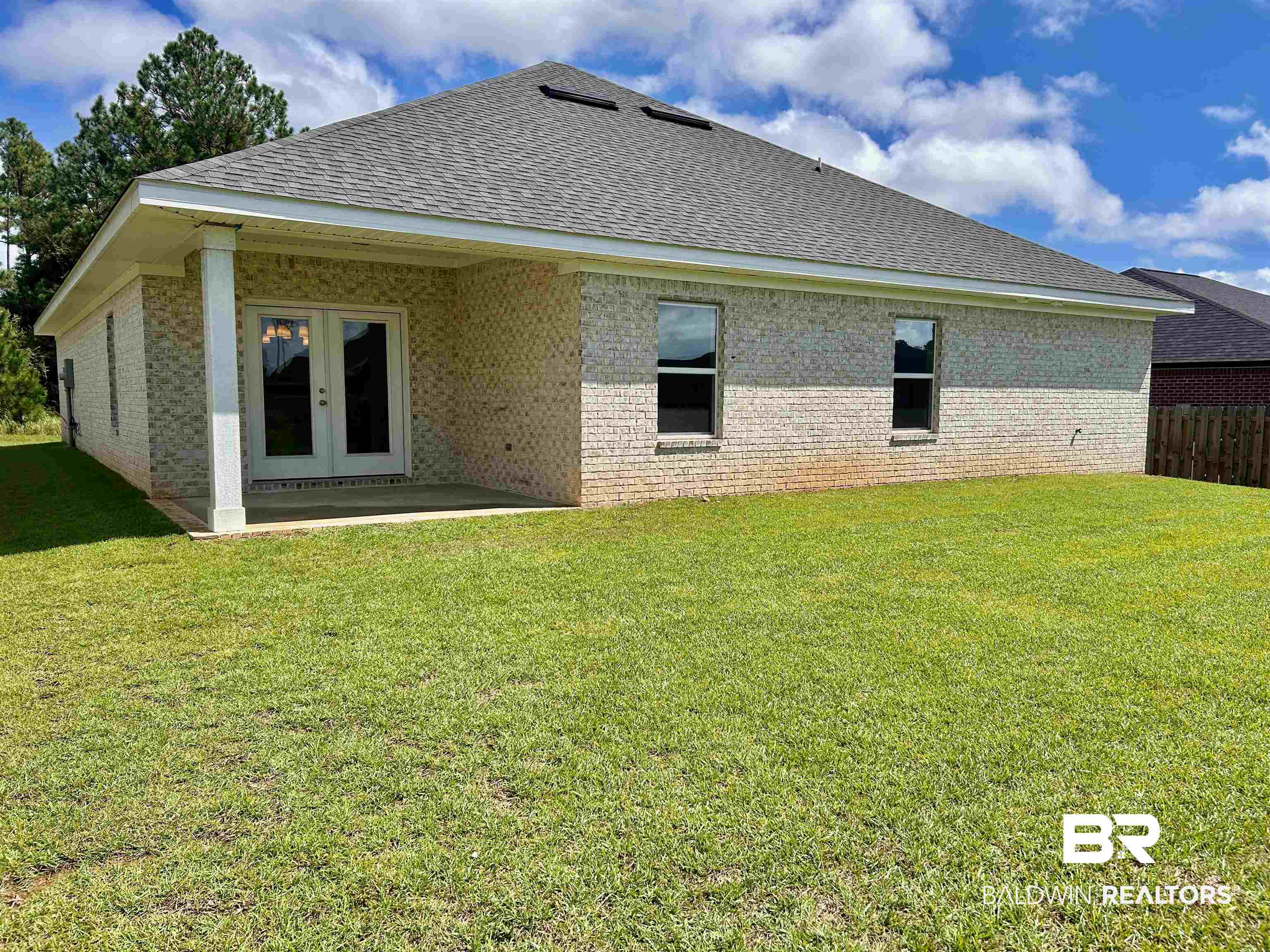 1267 Pembroke Way Foley, AL 36535 - Photo 17 of 17 Rear view of house featuring a yard and a patio