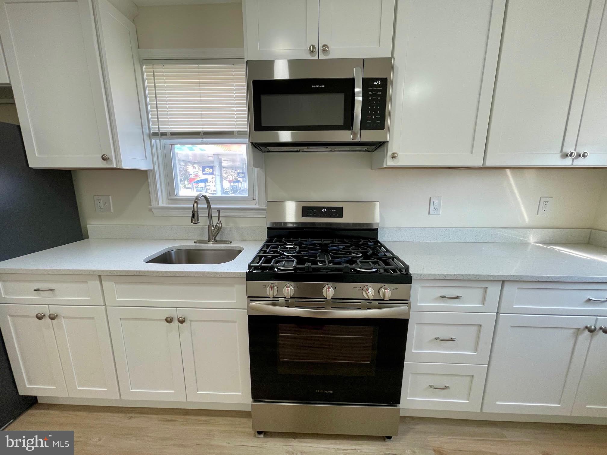 416 East Providence Road Aldan, PA 19018 - Photo 4 of 12 a kitchen with stainless steel appliances granite countertop white cabinets a stove a sink and dishwasher
