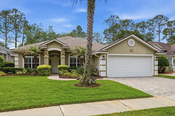 a front view of a house with a yard and garage