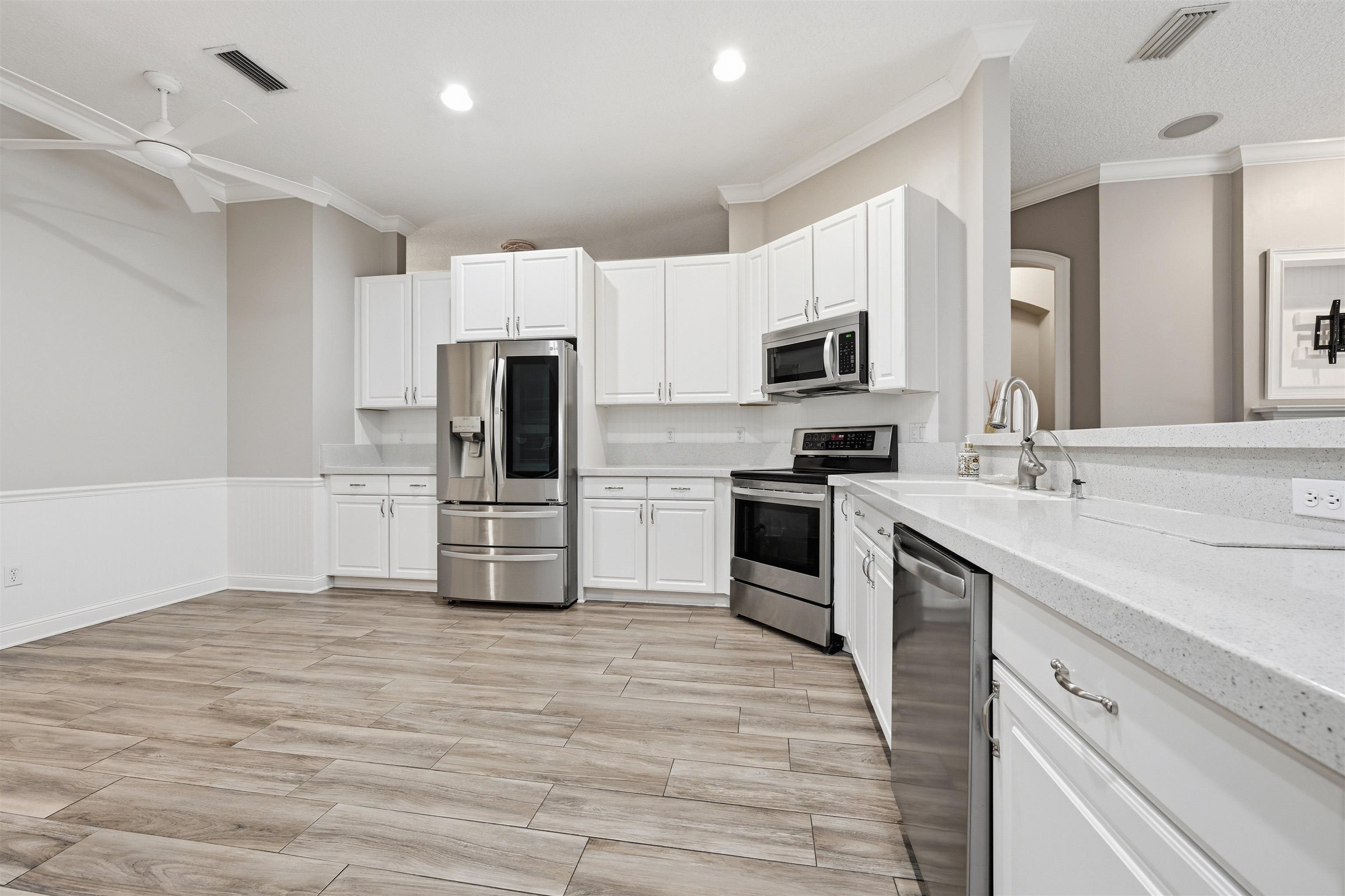 121 Edge Of Woods Road St. Augustine, FL 32092 - Photo 12 of 53 a kitchen with granite countertop a refrigerator and a stove top oven