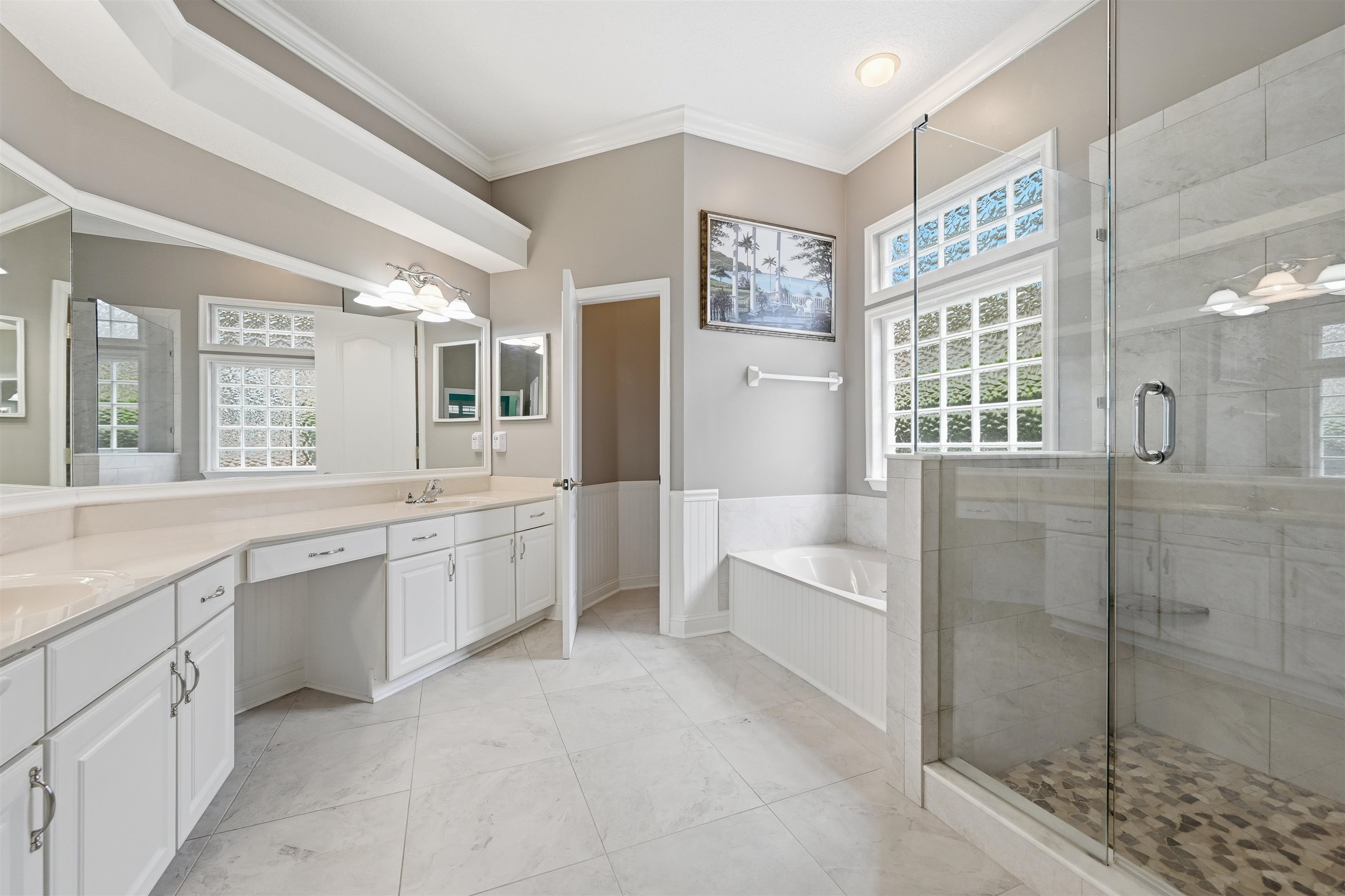 121 Edge Of Woods Road St. Augustine, FL 32092 - Photo 19 of 53 a large bathroom with a double vanity sink a large mirror and a bathtub