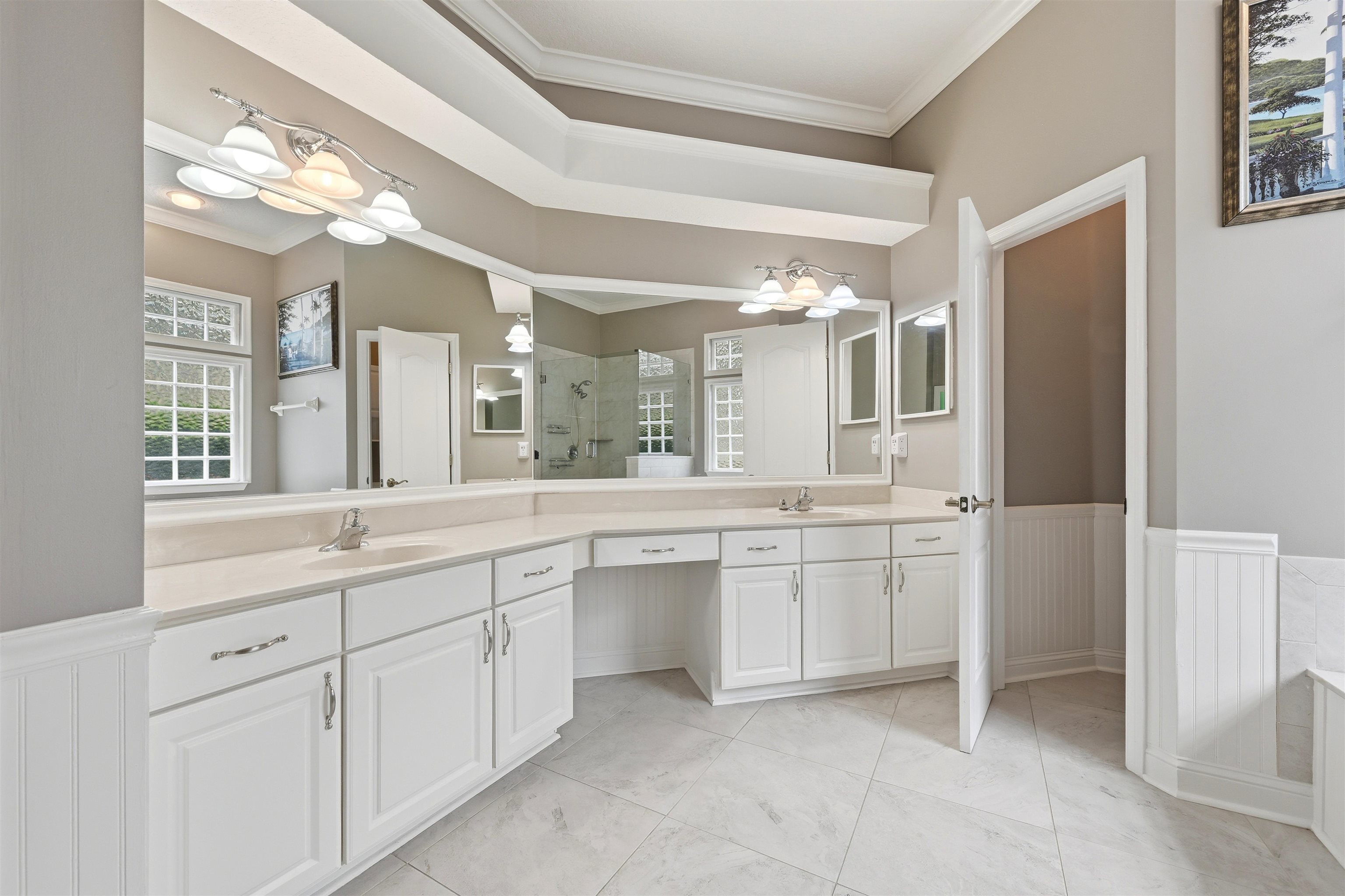 121 Edge Of Woods Road St. Augustine, FL 32092 - Photo 22 of 53 a large bathroom with a large mirror vanity and shower