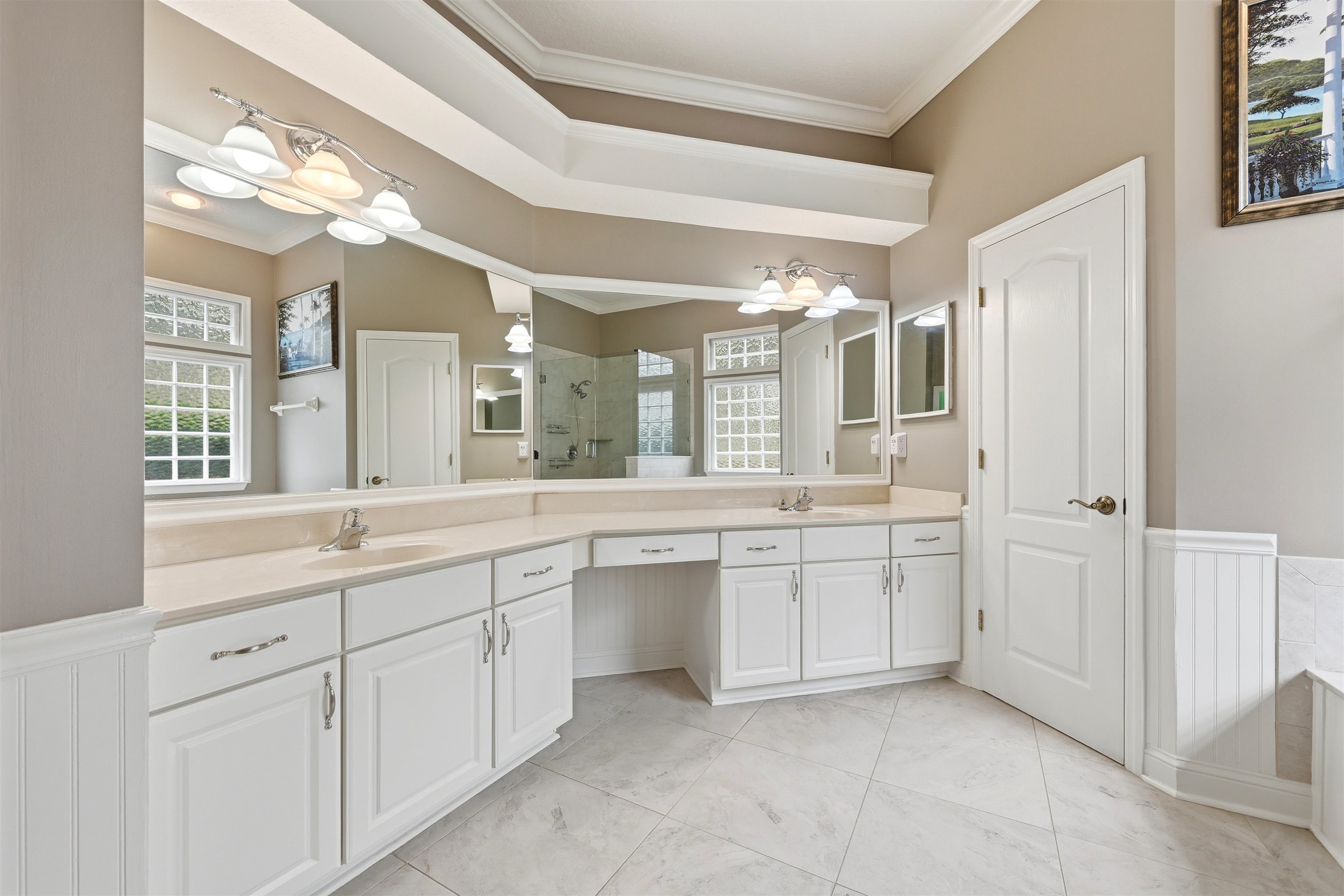 121 Edge Of Woods Road St. Augustine, FL 32092 - Photo 23 of 53 a large bathroom with a large mirror vanity and shower