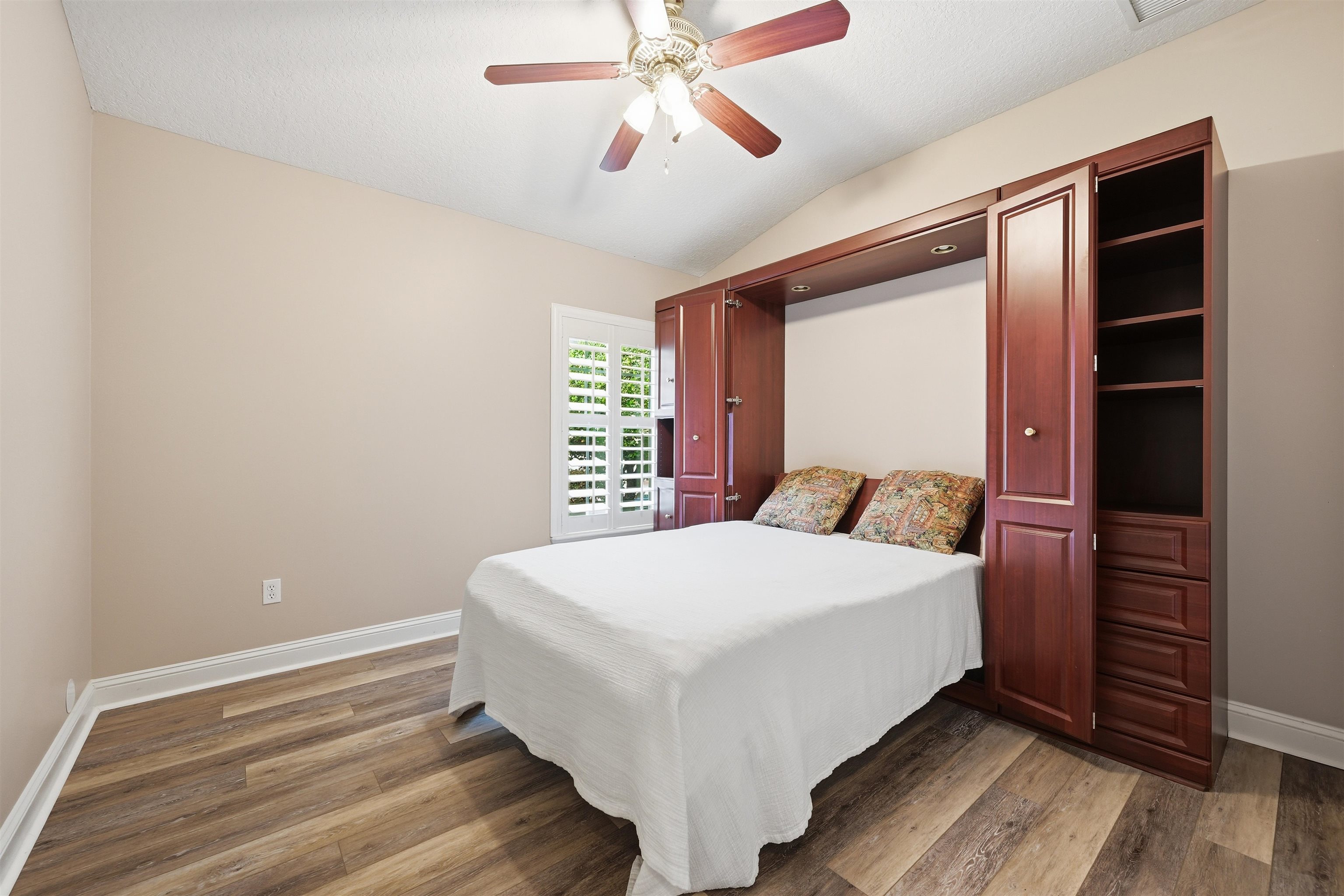121 Edge Of Woods Road St. Augustine, FL 32092 - Photo 29 of 53 a room with a bed and a ceiling fan