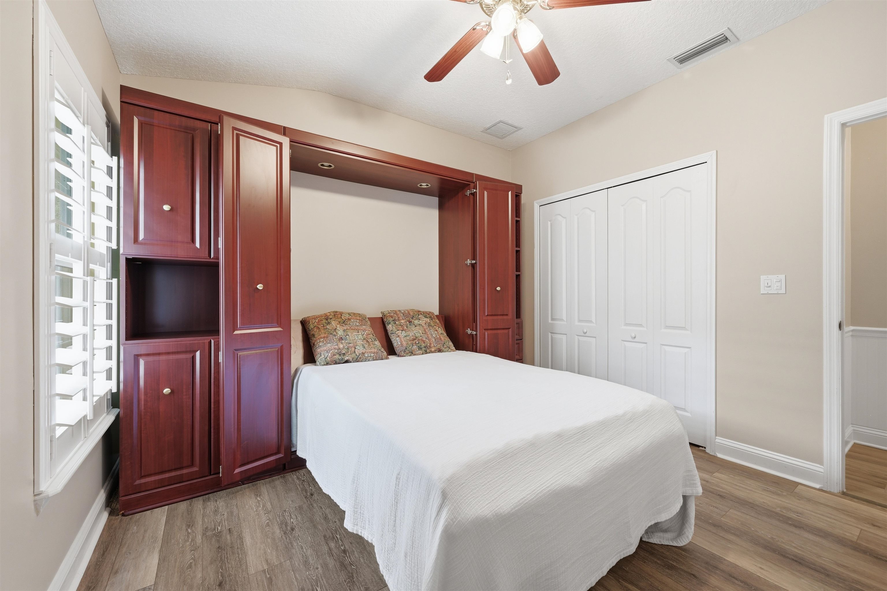 121 Edge Of Woods Road St. Augustine, FL 32092 - Photo 30 of 53 a bedroom with a bed and a flat tv screen on dresser