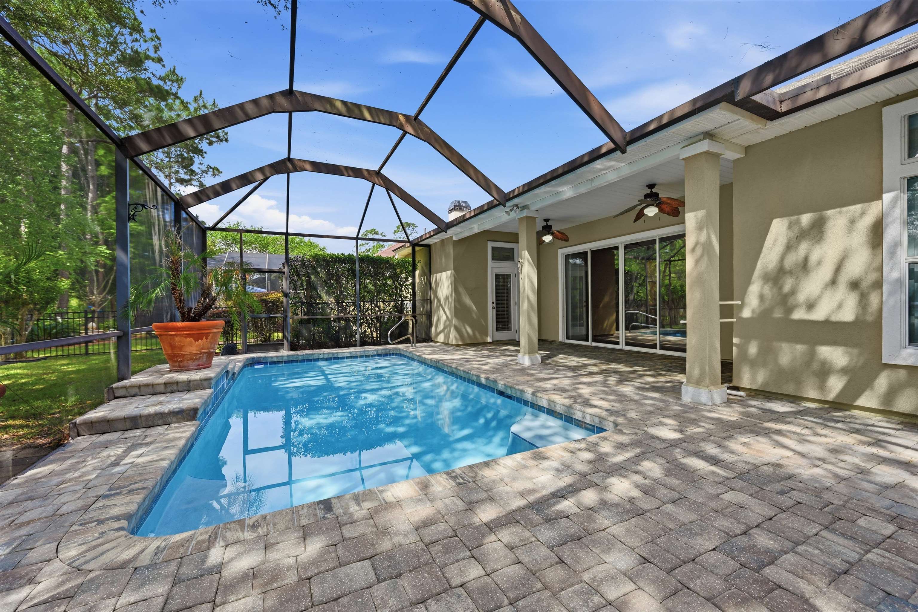 121 Edge Of Woods Road St. Augustine, FL 32092 - Photo 38 of 53 a view of a backyard with table and chairs under an umbrella