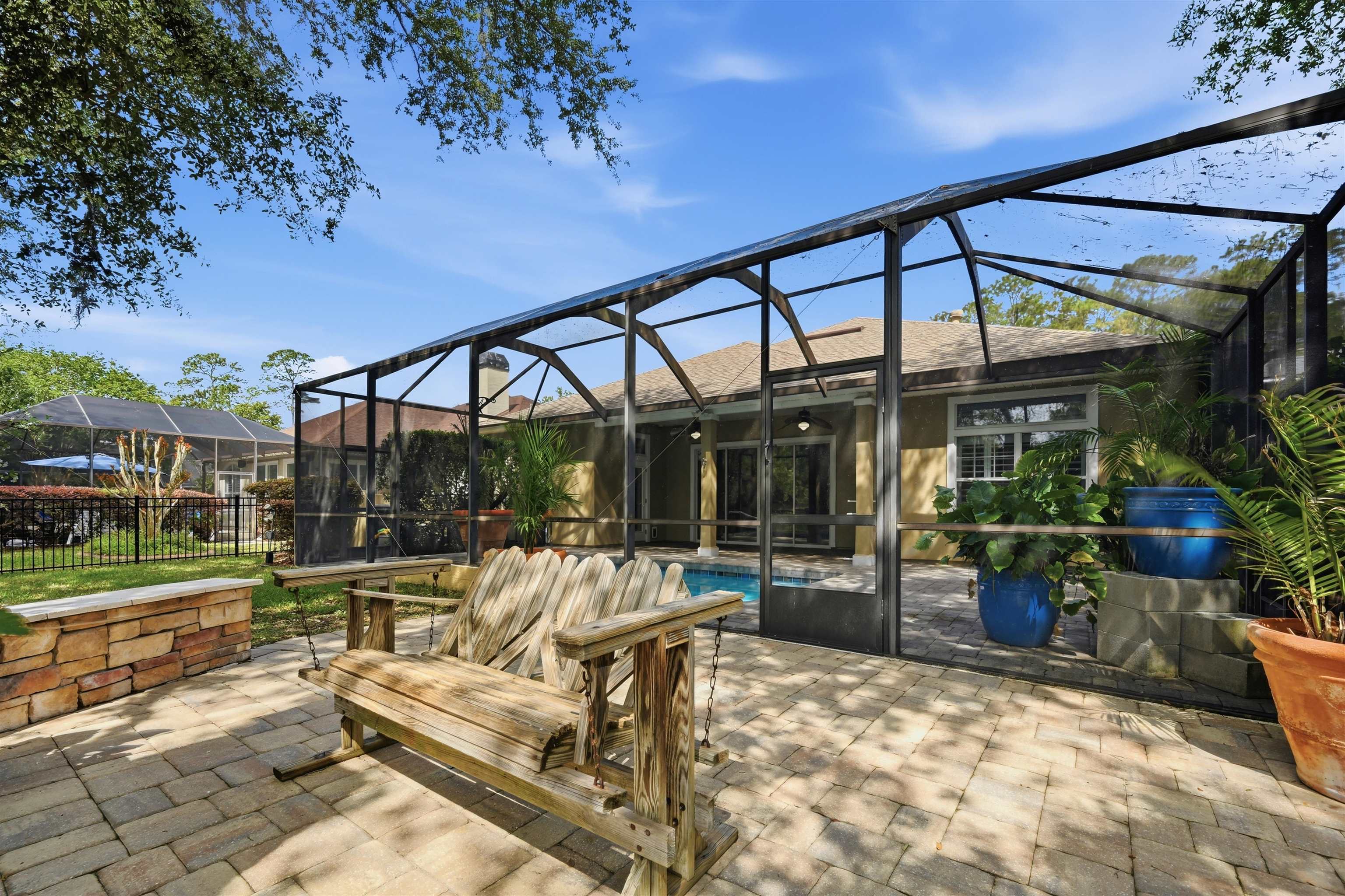 121 Edge Of Woods Road St. Augustine, FL 32092 - Photo 42 of 53 a view of a patio with a table and chairs and potted plants