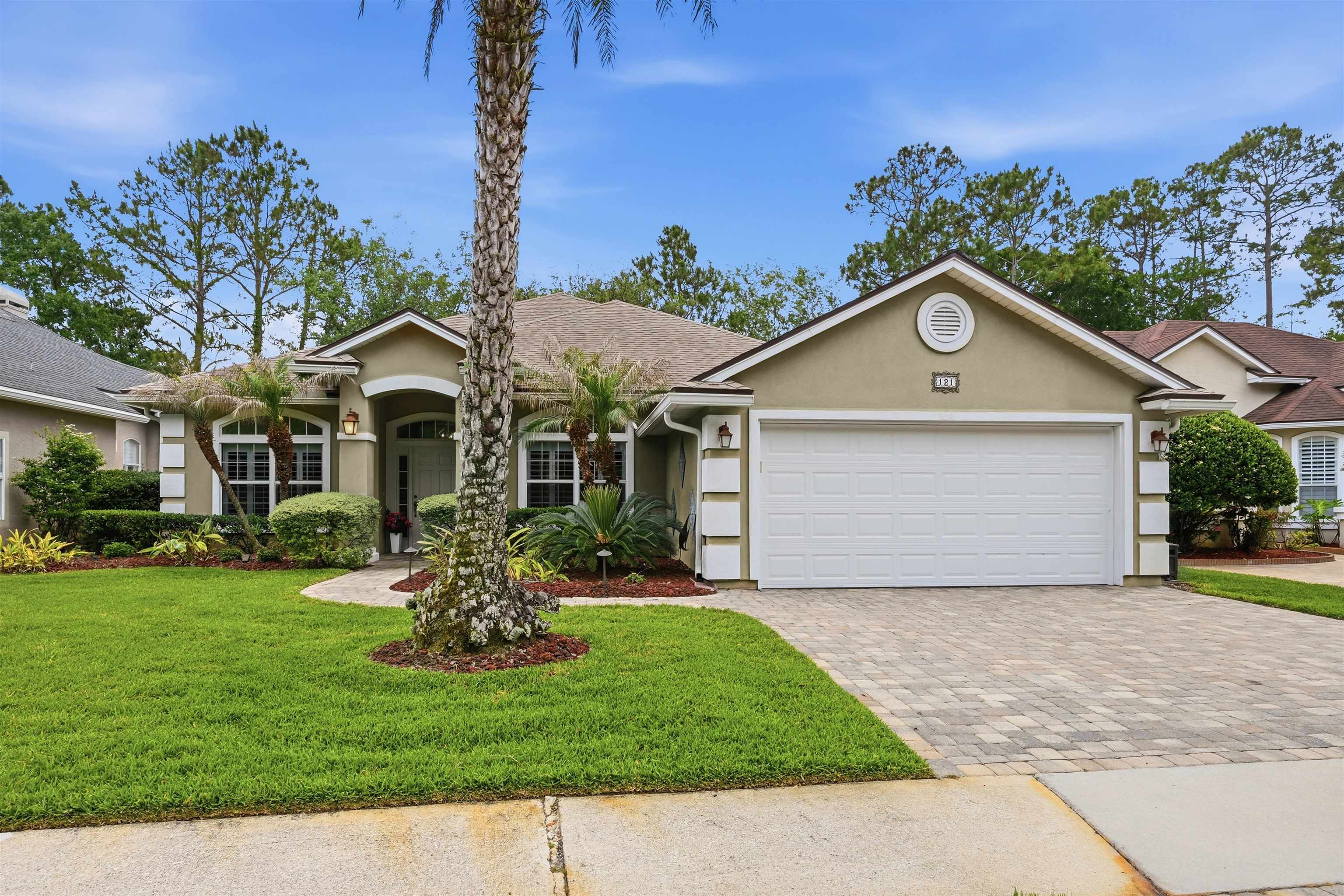 121 Edge Of Woods Road St. Augustine, FL 32092 - Photo 45 of 53 a front view of a house with a garden and yard