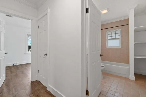 a bathroom with a toilet and a bath tub