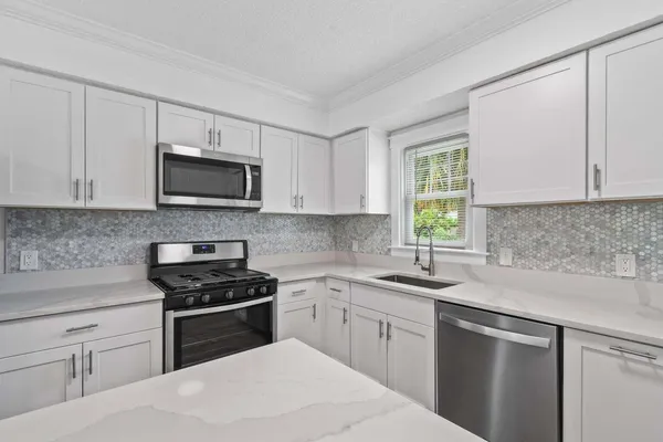 a kitchen with a sink stove and microwave