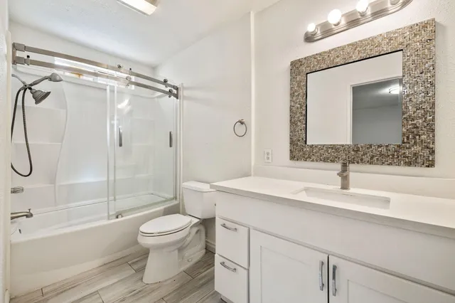 a bathroom with a sink toilet and shower