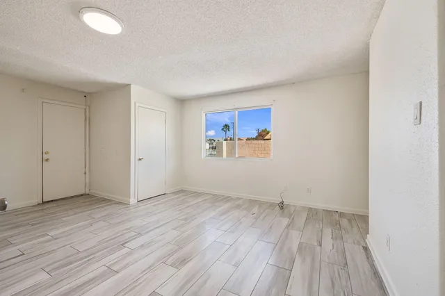 a view of an empty room and wooden floor