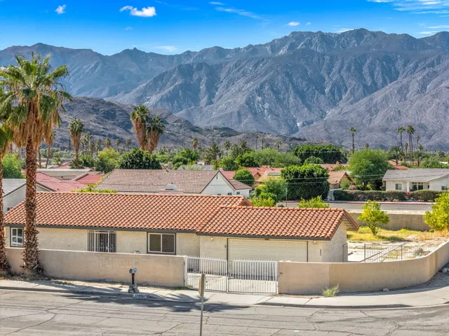 a view of a swimming pool and mountains in the background